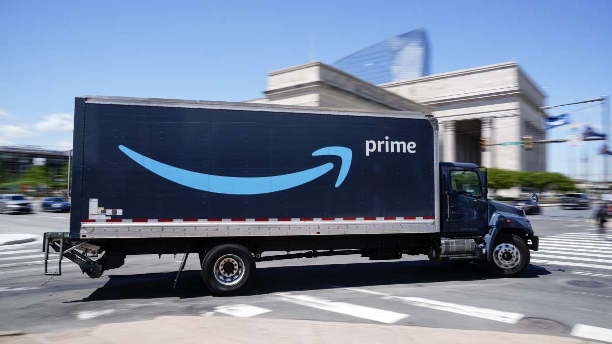 An Amazon truck drives in Philadelphia April 30. The number of Americans applying for unemployment aid rose last week for a second straight week to 351,000.