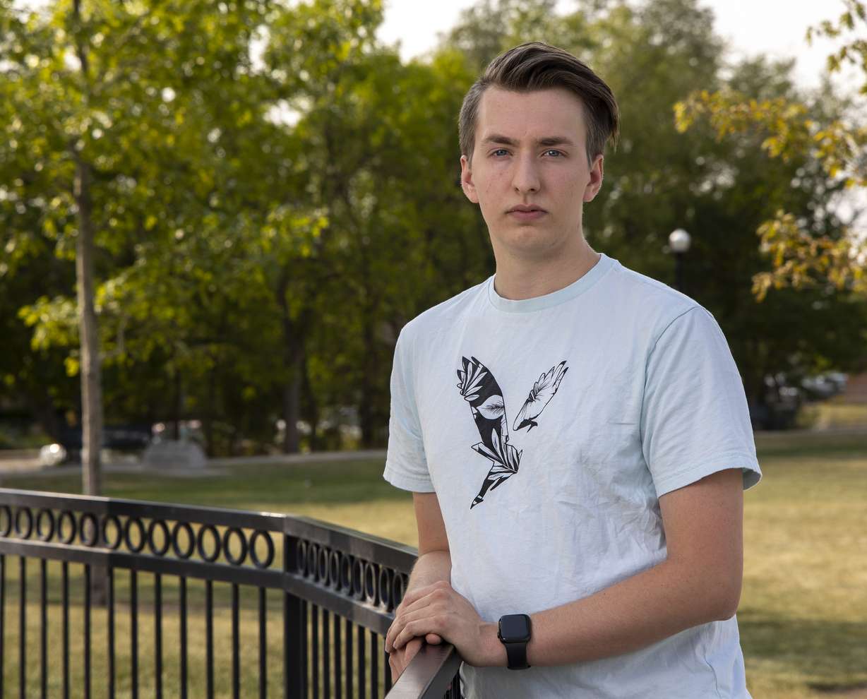 Cole Squire, a former certified nursing assistant at University of Utah Health, poses for photos at Heritage Park in Kaysville on Wednesday.