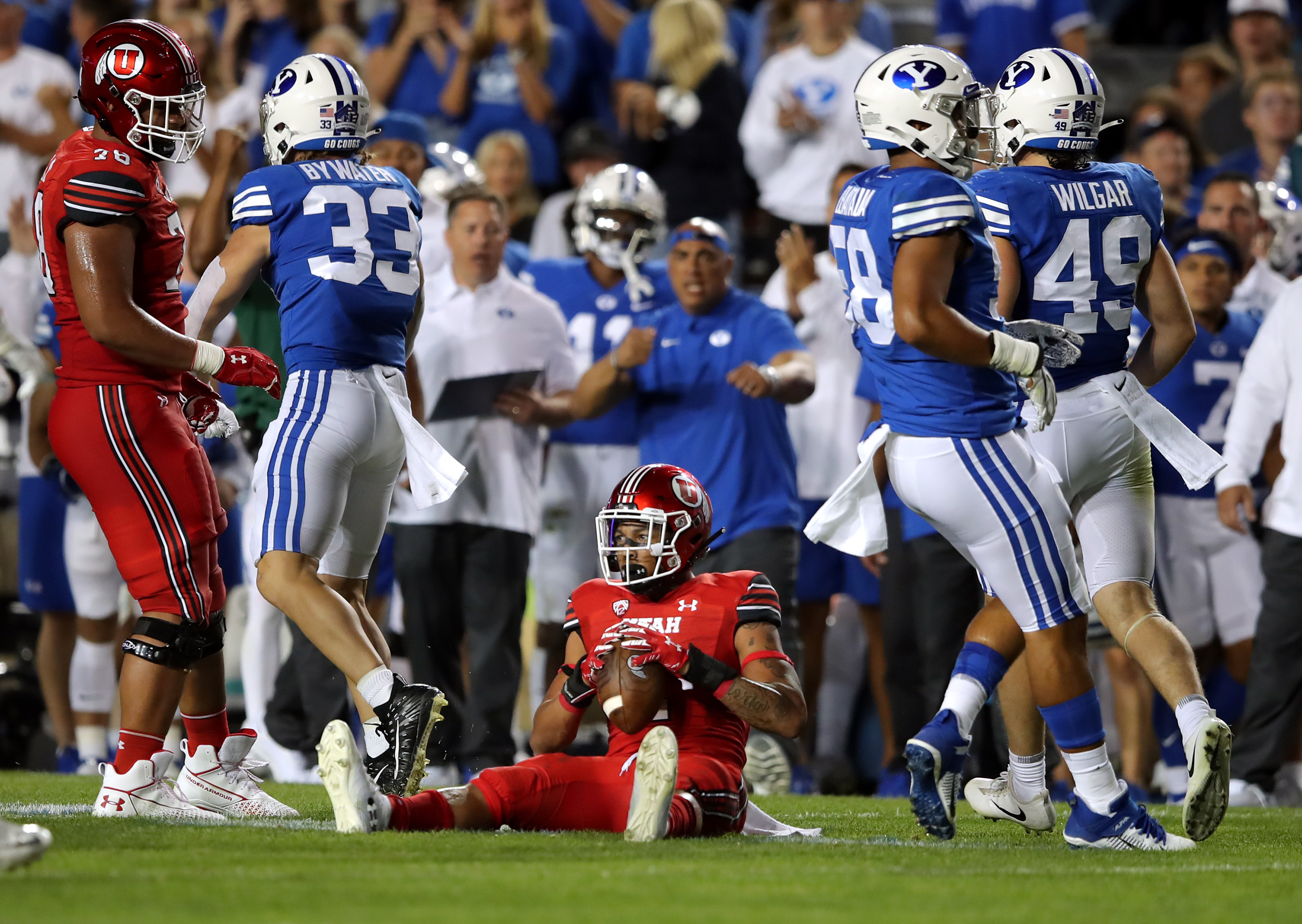 Utah Utes running back Micah Bernard (2) sits up after being hit by Brigham Young Cougars linebacker Ben Bywater (33) as BYU and Utah play an NCAA football game at LaVell Edwards Stadium in Provo on Saturday, Sept. 11, 2021. BYU won 26-17, ending a nine-game losing streak to the Utes.