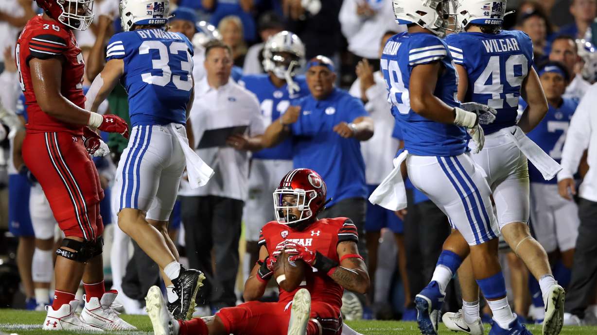 Utah Utes running back Micah Bernard (2) sits up after being hit by Brigham Young Cougars linebacker Ben Bywater (33) as BYU and Utah play an NCAA football game at LaVell Edwards Stadium in Provo on Saturday, Sept. 11, 2021. BYU won 26-17, ending a nine-game losing streak to the Utes.