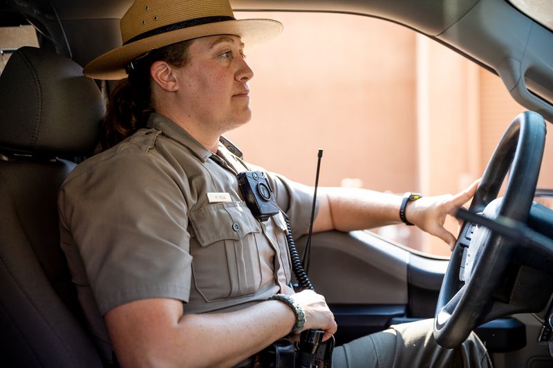 National Park Service ranger Melissa Hulls, the visitor
and resource protection supervisor for Arches National Park, poses
for a photo in her truck inside the park near Moab on Sunday, Sept.
19.