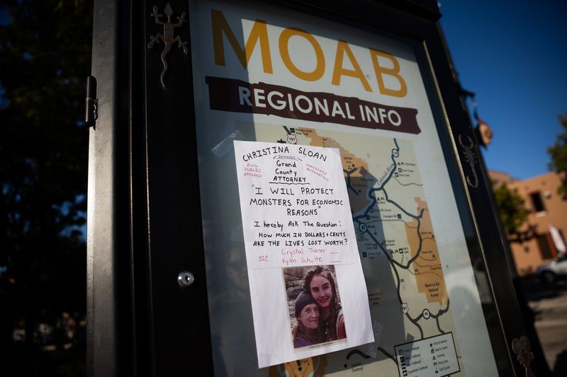A sign critical of the Grand County attorney in Moab on
Friday, Sept. 17, features a photograph of Kylen Schulte and
Crystal Turner.