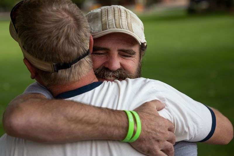 Sean-Paul Schulte hugs friend Scott Gorgacz in Swanny
City Park in Moab on Sunday, Sept. 19. Schulte has been in
the park every day for the past two weeks seeking community tips in
the murder of his daughter, Kylen Schulte, and her wife, Crystal
Turner.
