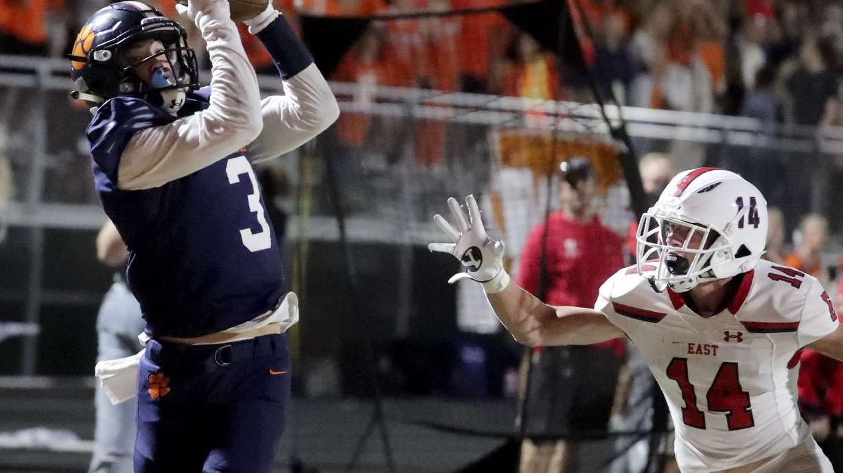 Brighton’s Dante McMaster catches a pass and scores in the first half against East’s Chase Barker at Brighton High School in Cottonwood Heights on Thursday, Sept. 22, 2021.