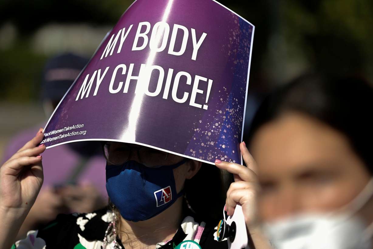 A demonstrator holds a pro-abortion rights sign as she listens to speakers at a Black Women Take Action event outside the U.S. Supreme Court building in Washington, Sept. 15.