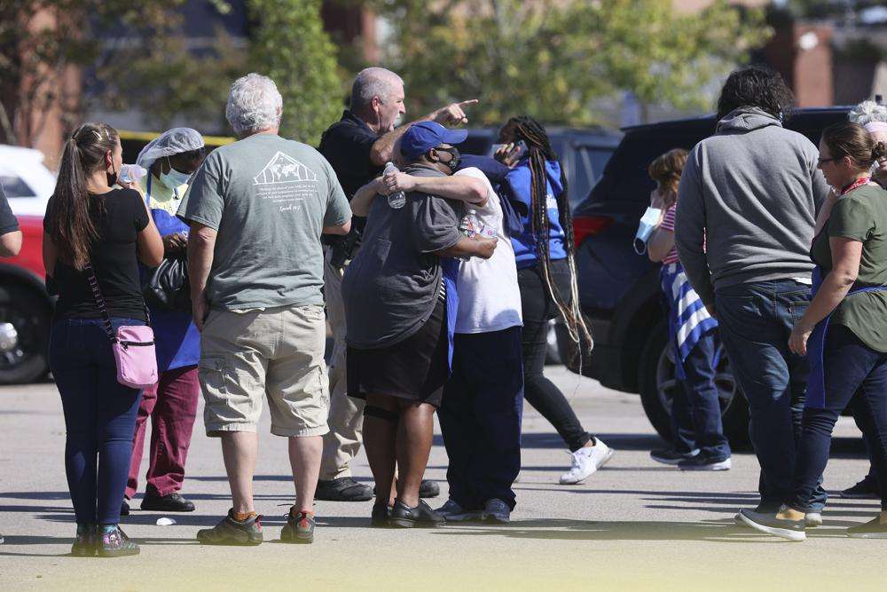 People embrace as police respond to the scene of a shooting at a Kroger's grocery store in Collierville, Tenn., on Thursday.