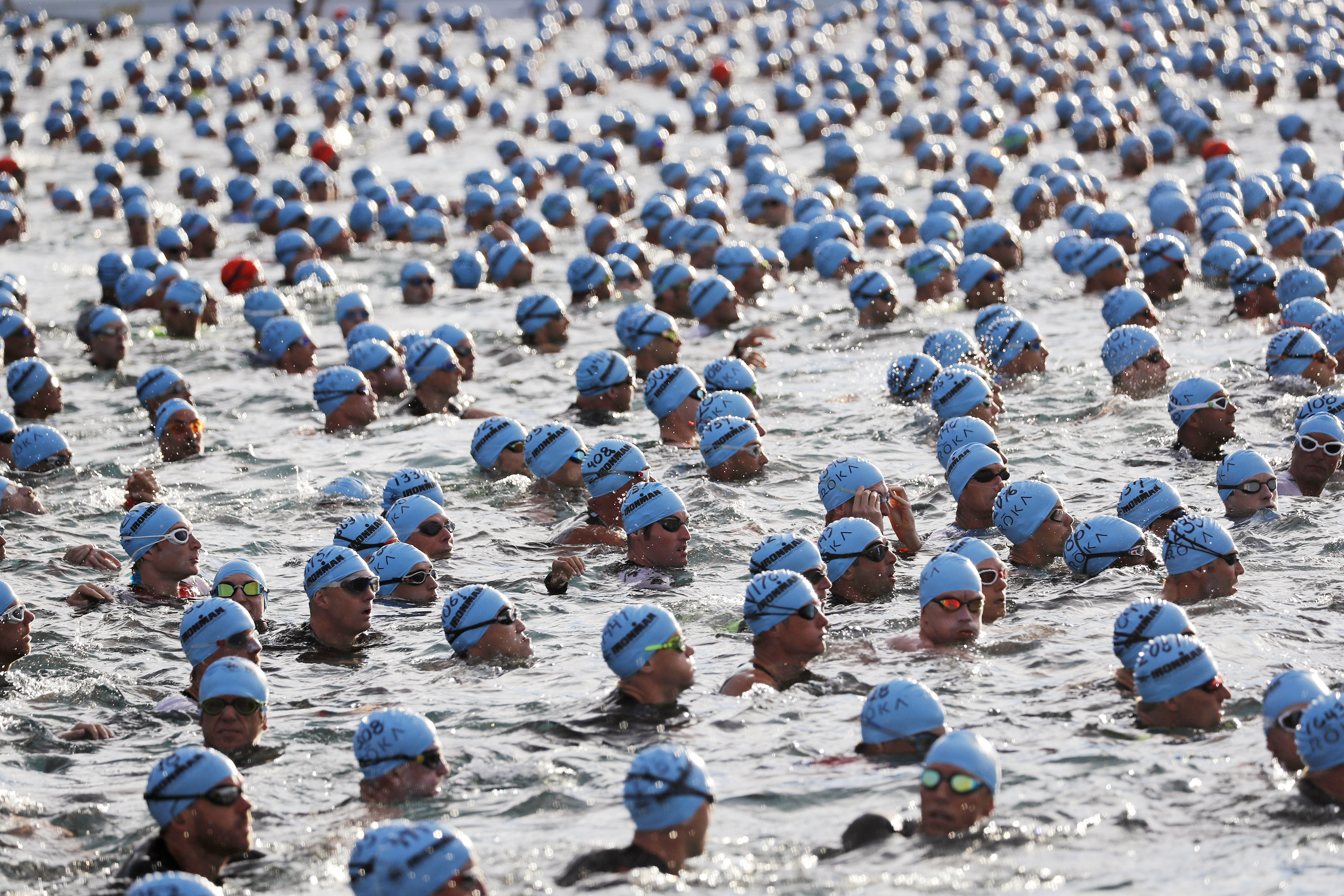 FILE - In this Oct. 13, 2018, file photo swimmers await the start of the race at the Ironman World Championship Triathlon, in Kailua Kona, Hawaii. The Ironman World Championship will be held outside Hawaii for the first time in four decades because of uncertainty over whether the Big Island will be able to host the triathlon as scheduled in February during the coronavirus pandemic. Competitors will instead head to St. George, Utah, on May 7.