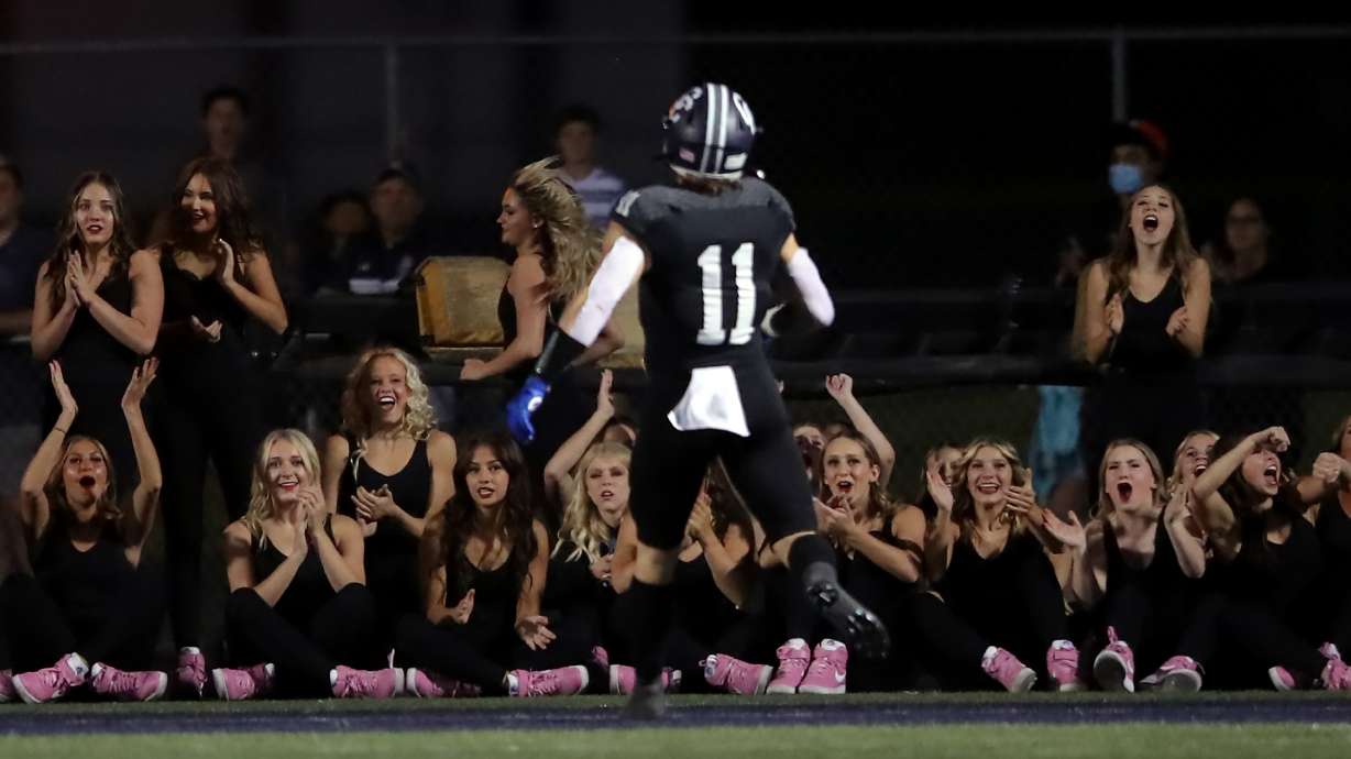Corner Canyon dancers cheer as Jett Meine runs into the end zone for a touchdown as Corner Canyon and Skyridge play a high school football game at Corner Canyon in Draper on Friday, Sept. 24, 2021. Corner Canyon won 38-23.