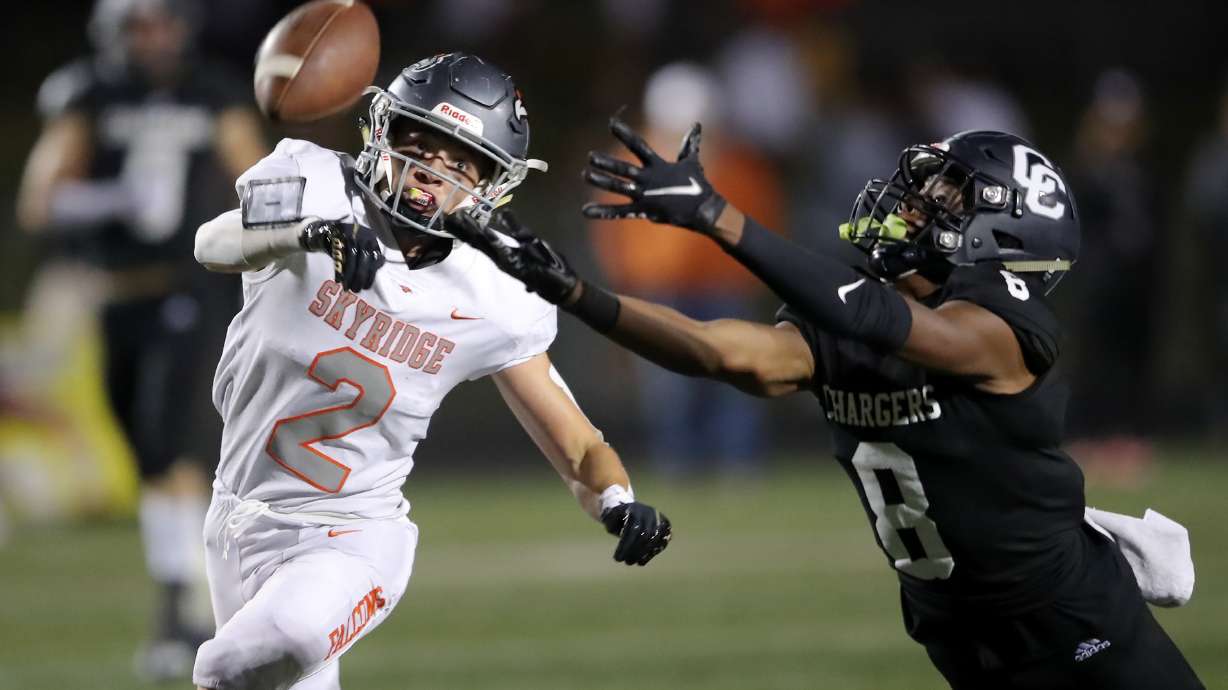 Corner Canyon’s Jared Malula dives trying to make an interception ahead of Skyridge’s Jack Hdfield as they play a high school football game at Corner Canyon in Draper on Friday, Sept. 24, 2021. Corner Canyon won 38-23.