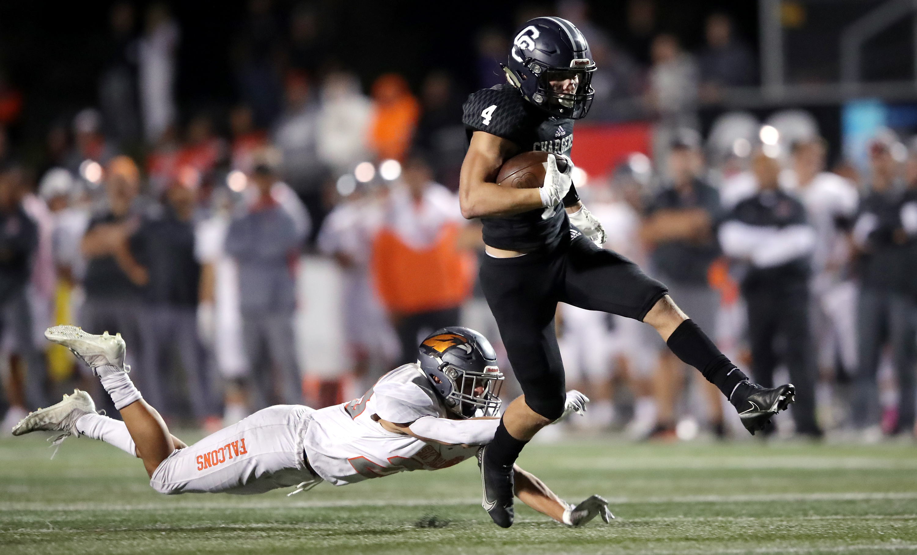 Corner Canyon’s Blaze DeGracie high kicks out of a tackle attempts by Skyridge’s Dalton Young falls to the turf as they play a high school football game at Corner Canyon in Draper on Friday, Sept. 24, 2021. Corner Canyon won 38-23.