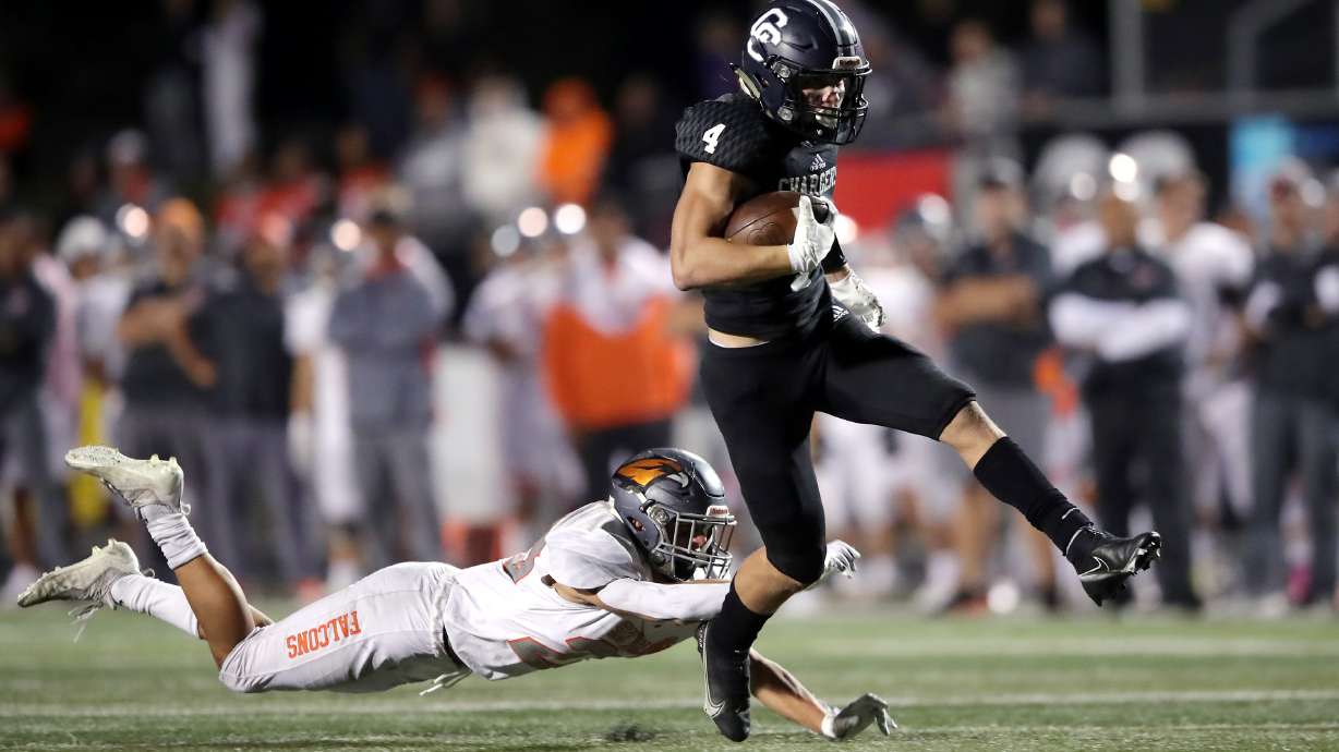 Corner Canyon’s Blaze DeGracie high kicks out of a tackle attempts by Skyridge’s Dalton Young falls to the turf as they play a high school football game at Corner Canyon in Draper on Friday, Sept. 24, 2021. Corner Canyon won 38-23.