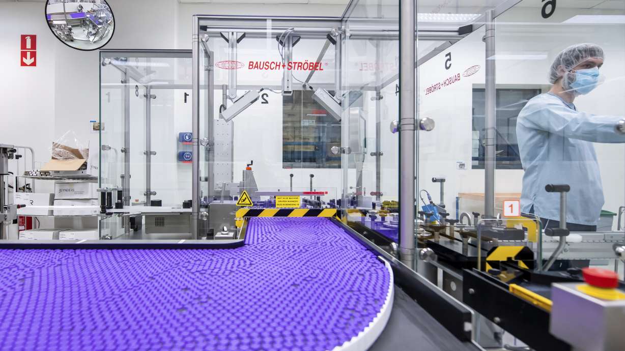 In this March 2021 photo provided by Pfizer, a technician works on a line for packaging preparation for the Pfizer-BioNTech COVID-19 vaccine at the company's facility in Puurs, Belgium.