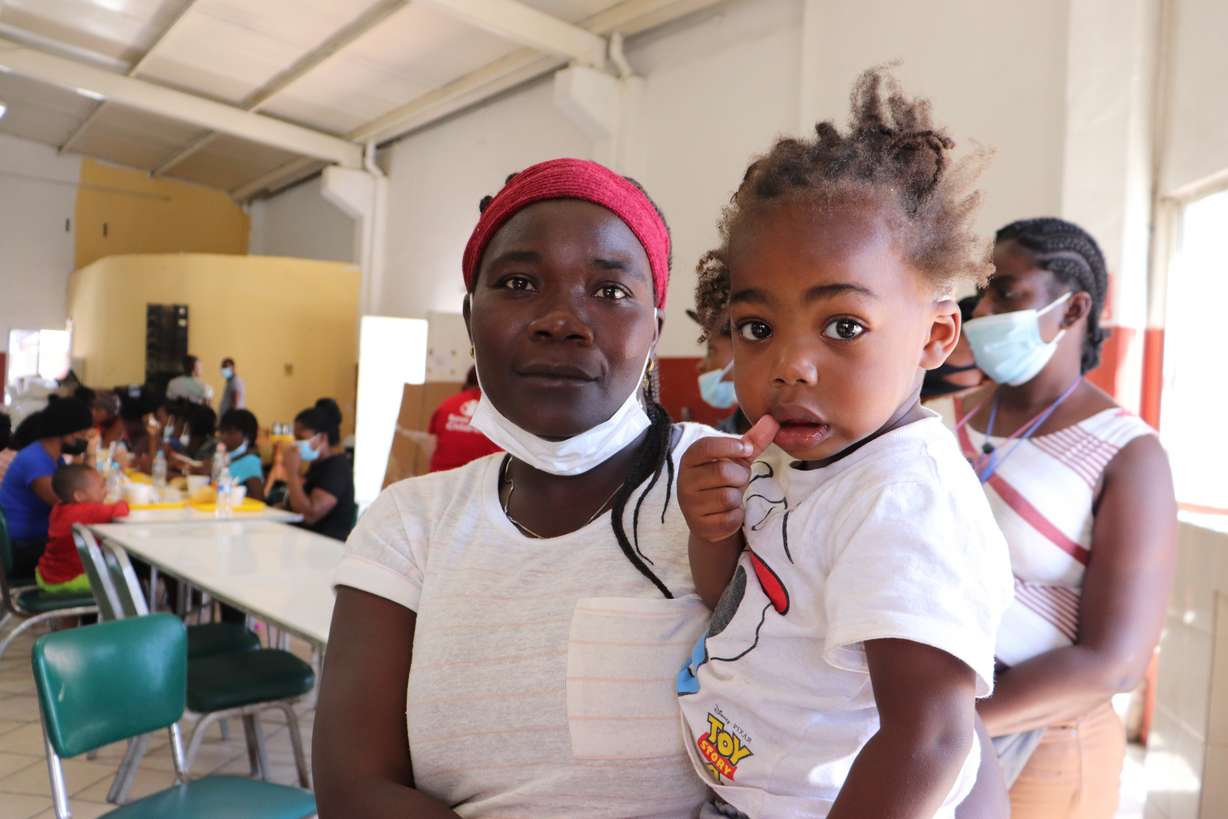 Ana Estache, from Port-au-Prince, Haiti, poses for a photo with her two-year-old son in Monterrey, Mexico, on Thursday after traveling from Chile where they lived before.