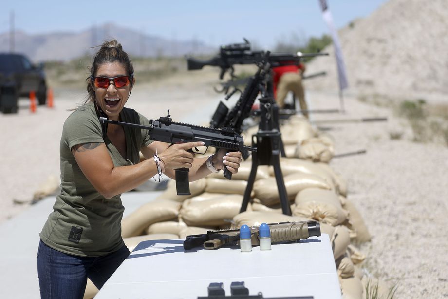 Professional shooter Michelle Viscusi reacts after firing a Heckler & Koch MP7 during the filming of a promotional video for a TacGas client at Special Weapons Test Center near Grantsville on Wednesday, May 12, 2021.
