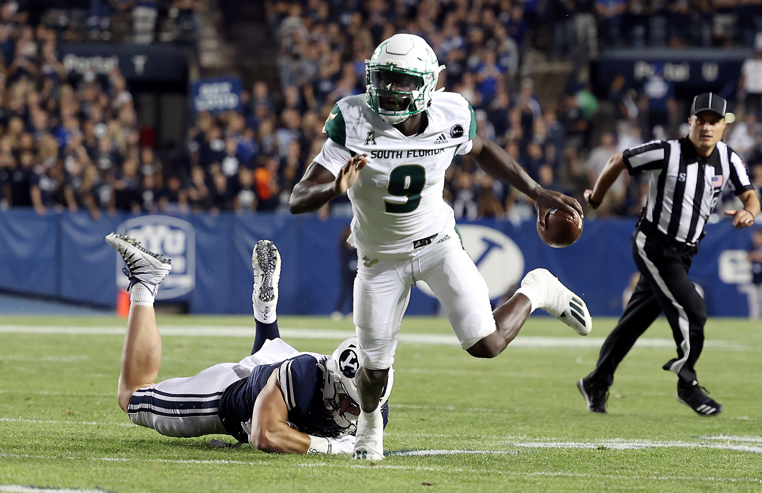 South Florida Bulls quarterback Timmy McClain (9) runs away from Brigham Young Cougars defensive lineman Fisher Jackson (53) as BYU and USF play a college football game at LaVell Edwards Stadium in Provo on Saturday, Sept. 25, 2021. BYU won 35-27.