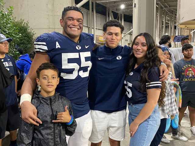 BYU defensive lineman Lorenzo Fauatea, middle, with his wife Chastina and her family, including brother JJ (right) who went viral during Saturday's game between BYU and South Florida after the ESPN2 broadcast mistakenly identified Tuha as quarterback Jaren Hall.