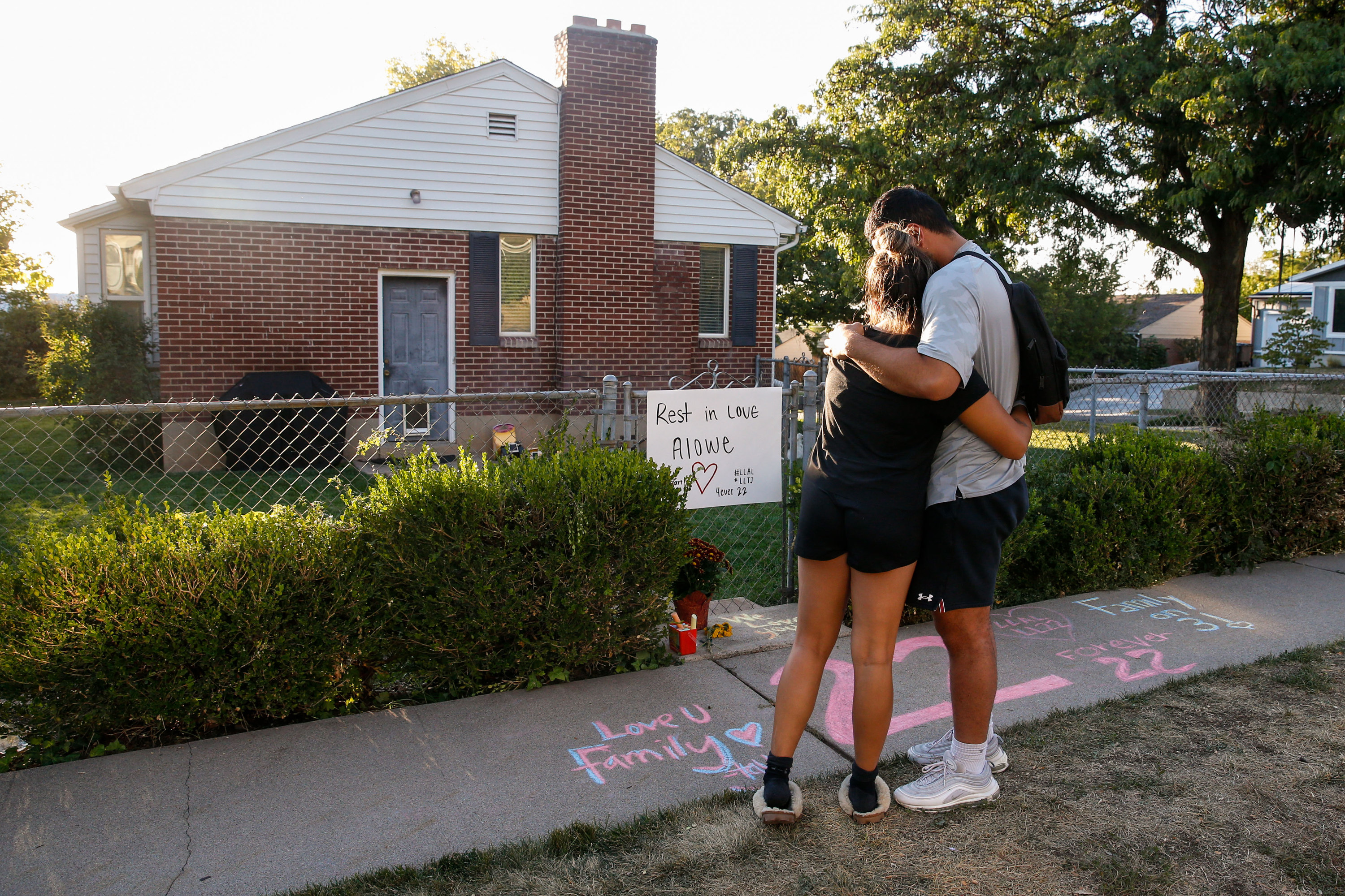 Samuelu Elisaia, right, former University of Utah football player and teammate of sophomore defensive back Aaron Lowe and University of Utah student, Madison Jacobus embraces each other in front of a makeshift memorial at the incident of shooting on Sunday in Salt Lake City’s Sugar House neighborhood. University of Utah sophomore and football defensive back Aaron Lowe was shot and killed early Sunday morning during a house party.