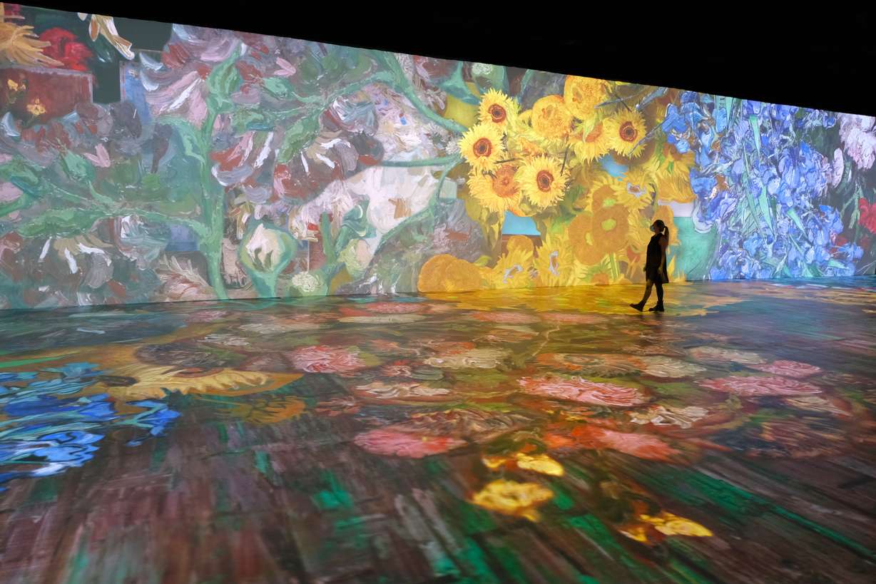 Spectators stroll through a 3D projection of Vincent Van Gogh's artwork during the opening of the "Beyond Van Gogh" exhibit in Miami on April 12. The exhibit will open at Atmosphere Studios in Salt Lake City on Oct. 8.