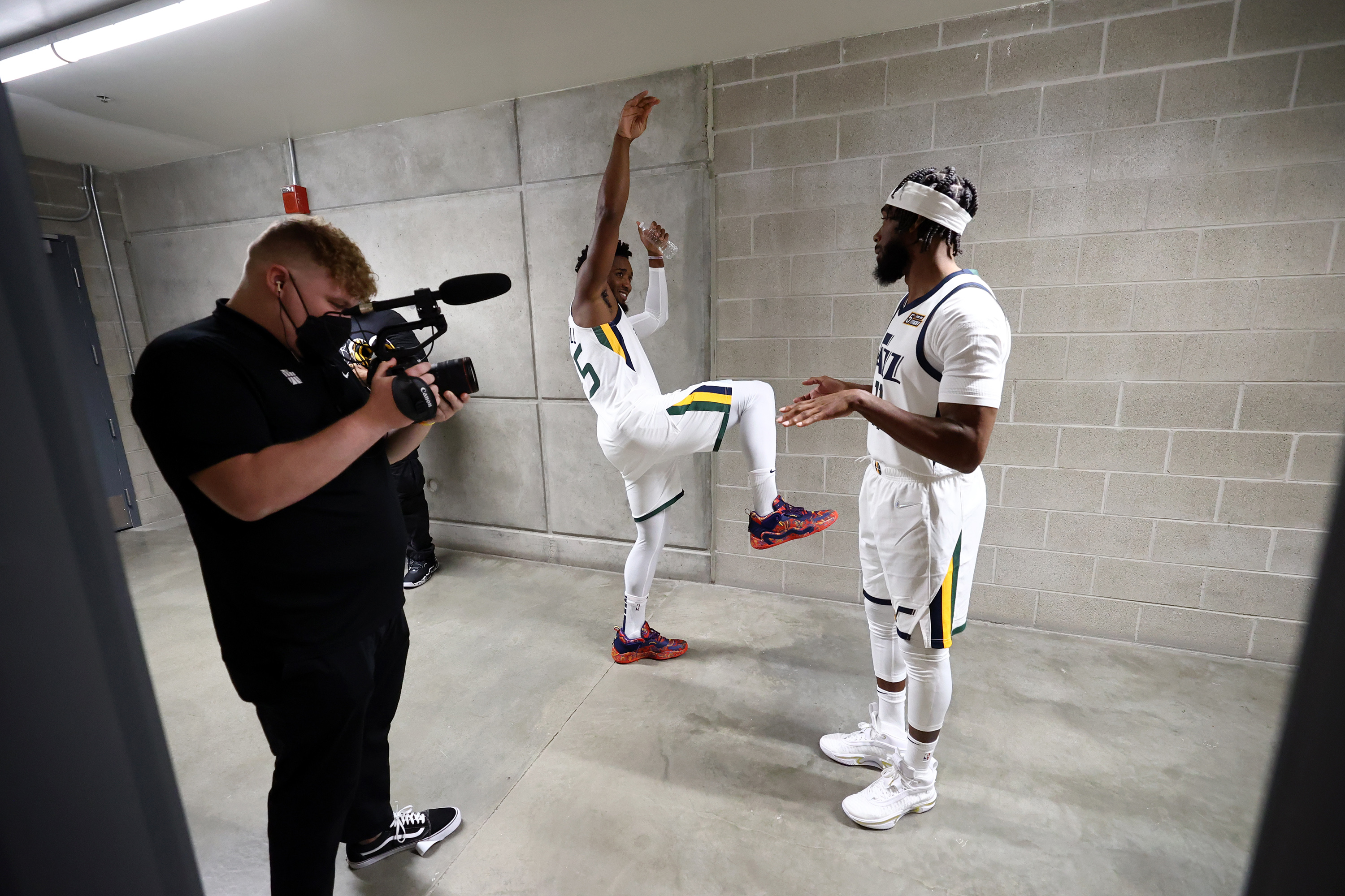 Utah Jazz guard Donovan Mitchell (45) and Jazz guard Mike Conley (11) talk in the hallway after being interviewed during the Utah Jazz media day at Vivint Arena in Salt Lake City on Monday.