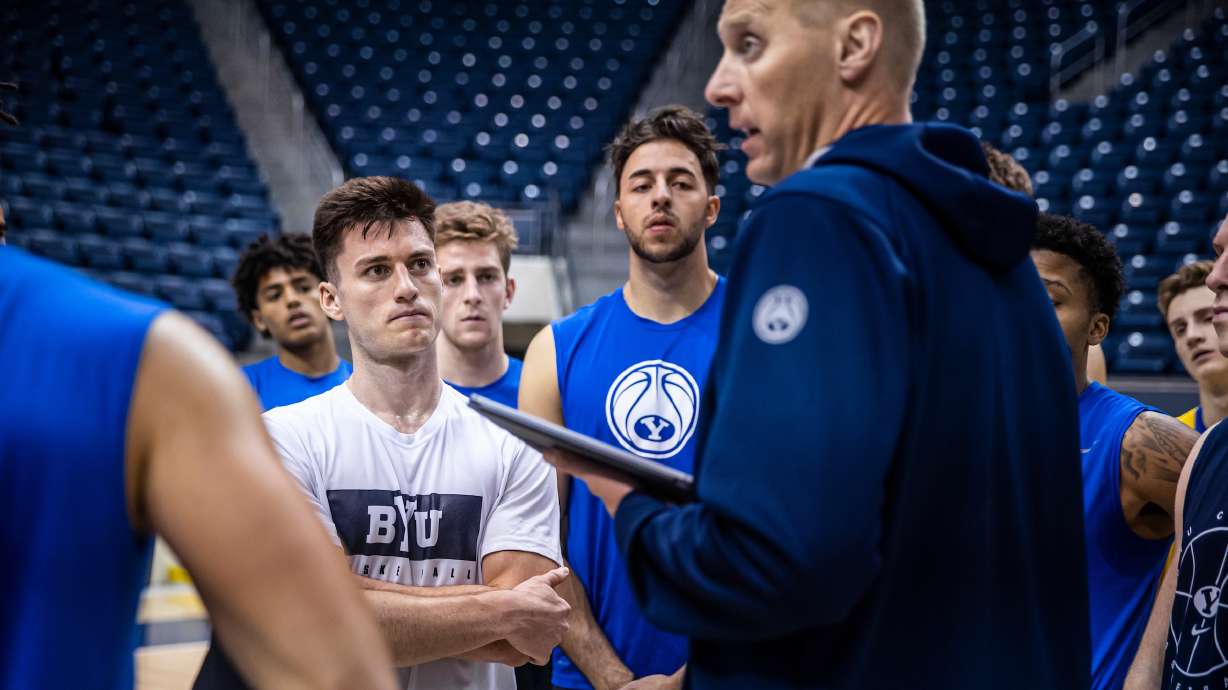 BYU guard Alex Barcello, left, listens as coach Mark Pope directs practice over the summer. The Cougars opened official preparations for the 2021-22 season Tuesday, Sept. 28, 2021 with two-a-day practices.
