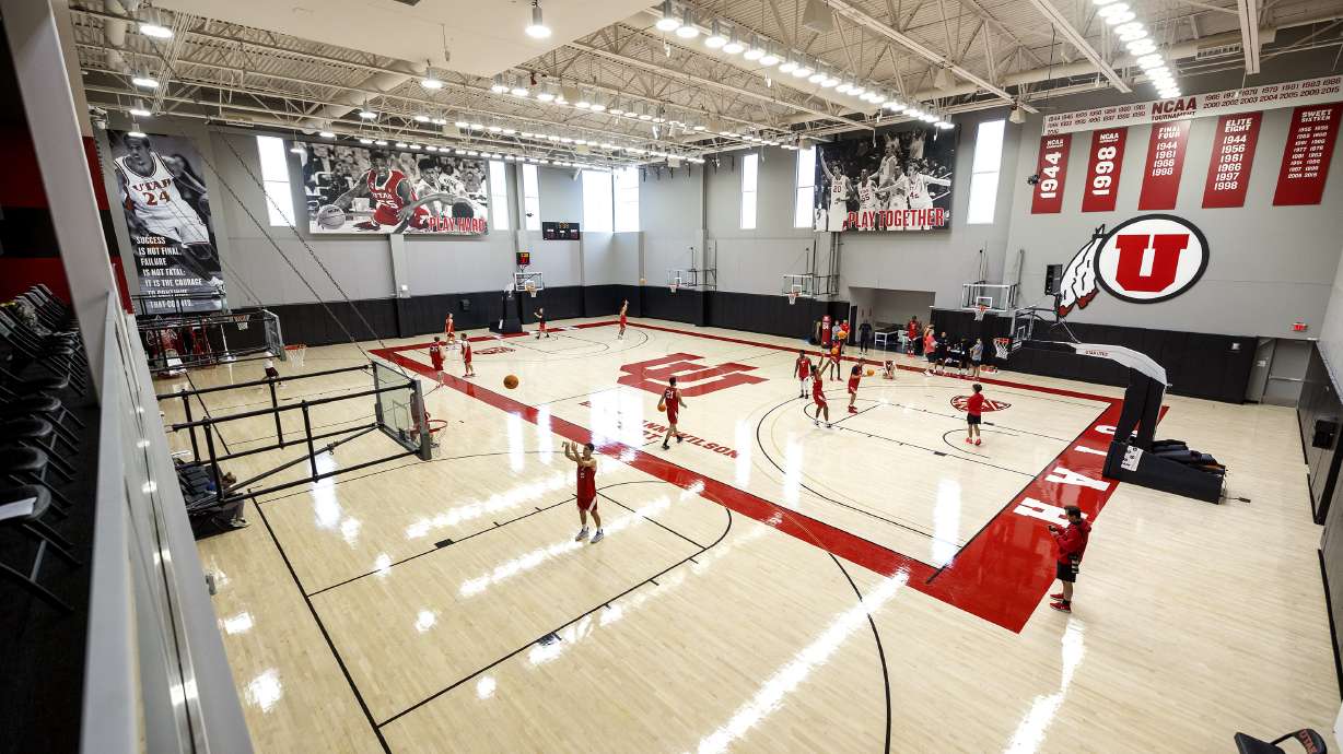 Players begin warming up as the University of Utah’s men’s basketball team opens camp with practice inside the Jon M. and Karen Huntsman Basketball Facility in Salt Lake City on Tuesday, Sept. 28, 2021.