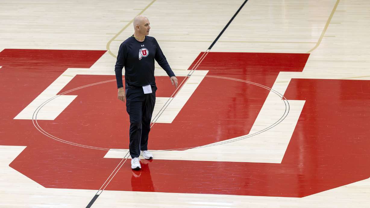 Head coach Craig Smith walks at midcourt as the University of Utah’s men’s basketball team opens camp with practice inside the Jon M. and Karen Huntsman Basketball Facility in Salt Lake City on Tuesday, Sept. 28, 2021.