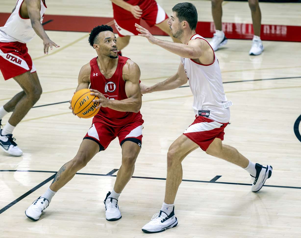Marco Anthony looks to fake Riley Battin during a scrimmage as the University of Utah’s men’s basketball team opens camp with practice inside the Jon M. and Karen Huntsman Basketball Facility in Salt Lake City on Tuesday, Sept. 28, 2021.