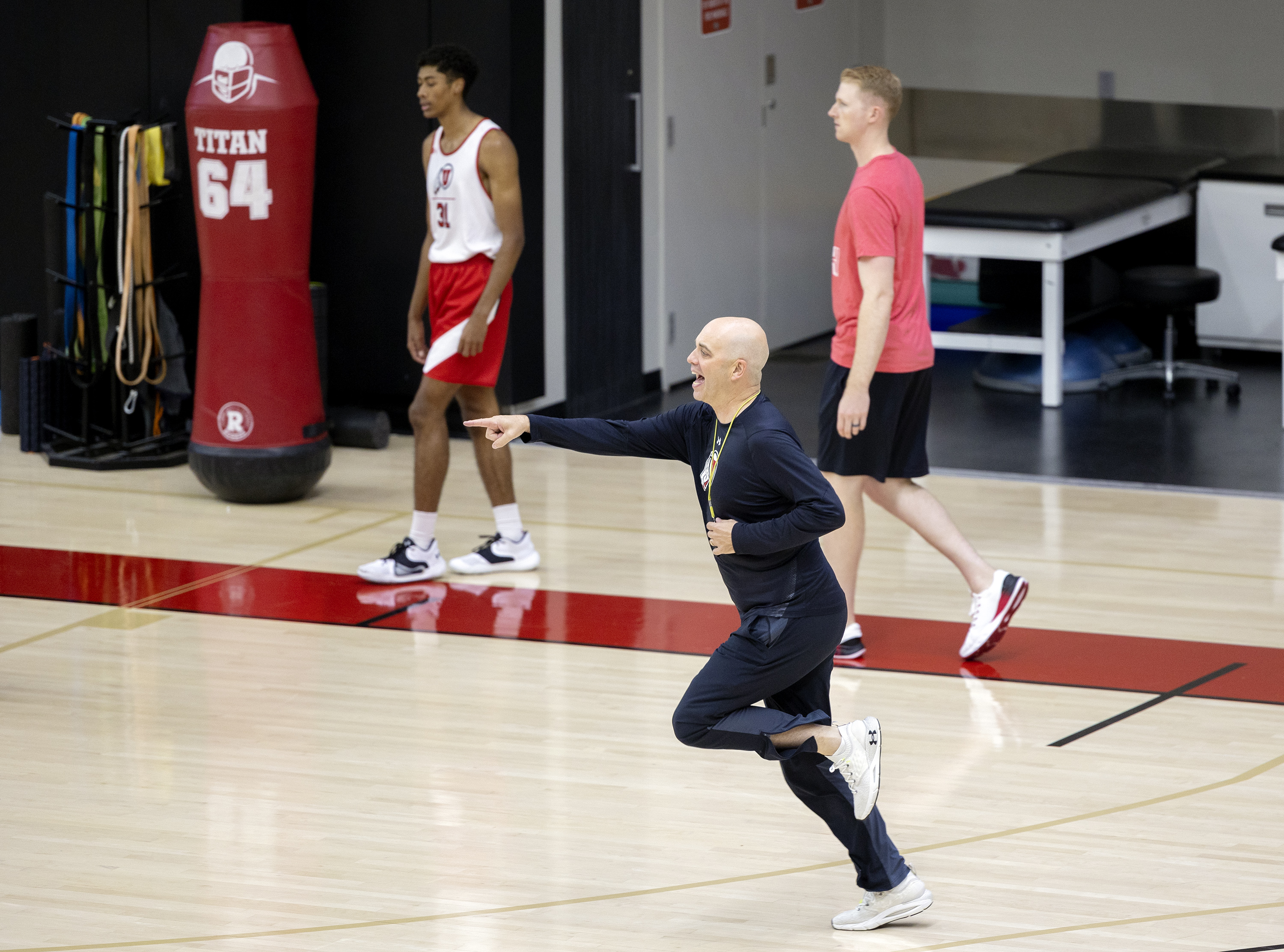 Head coach Craig Smith points as he runs onto the floor as the University of Utah’s men’s basketball team opens camp with practice inside the Jon M. and Karen Huntsman Basketball Facility in Salt Lake City on Tuesday, Sept. 28, 2021.