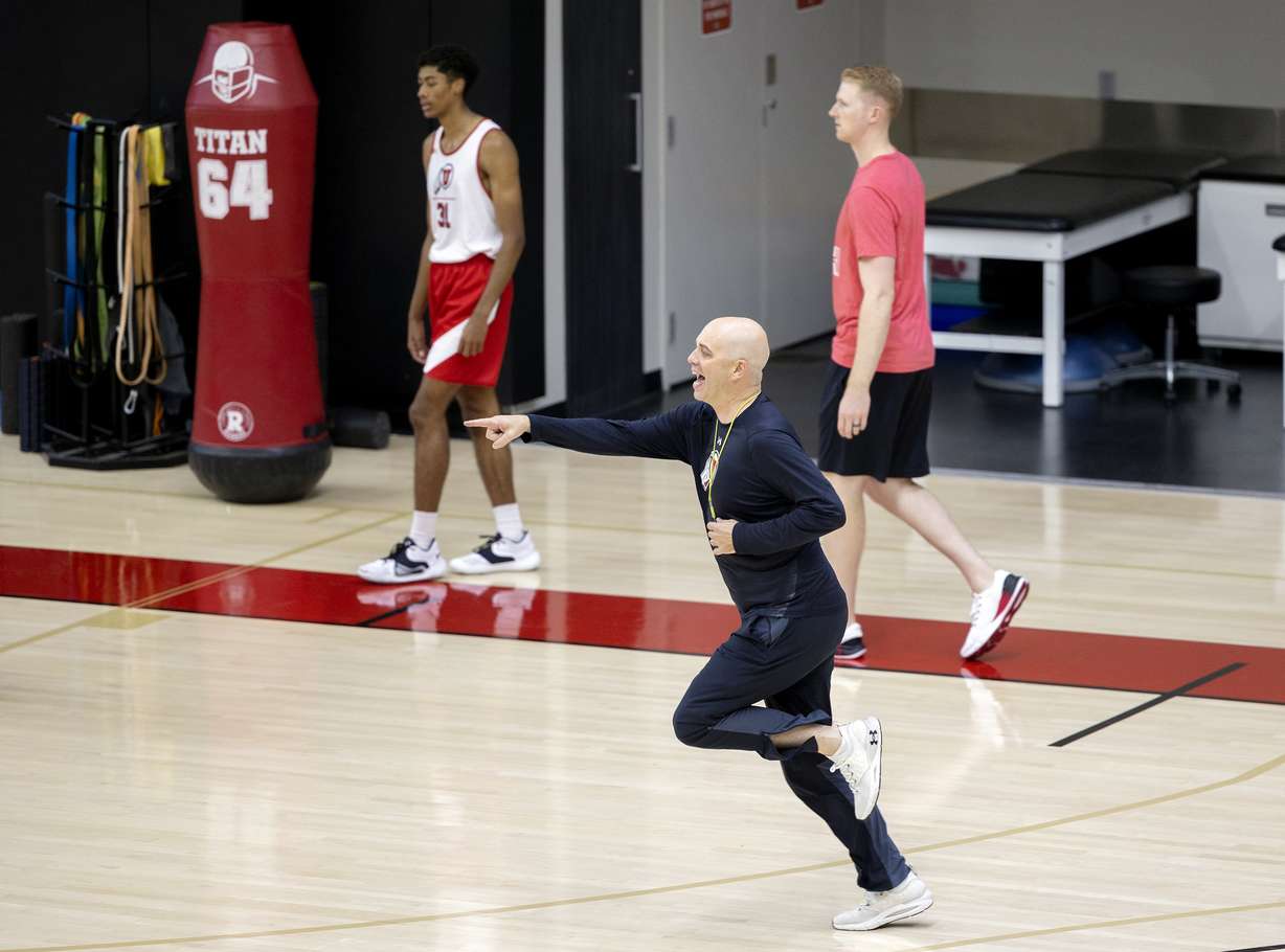 Head coach Craig Smith points as he runs onto the floor as the University of Utah’s men’s basketball team opens camp with practice inside the Jon M. and Karen Huntsman Basketball Facility in Salt Lake City on Tuesday, Sept. 28, 2021.