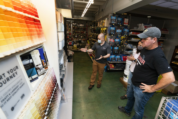 Billy Wommack, purchasing director at the W.S. Jenks & Sons hardware, left, works with customer Tim Wood, right, picking a paint color for an outdoor painting work at his house, Sept. 24, in northeast Washington.