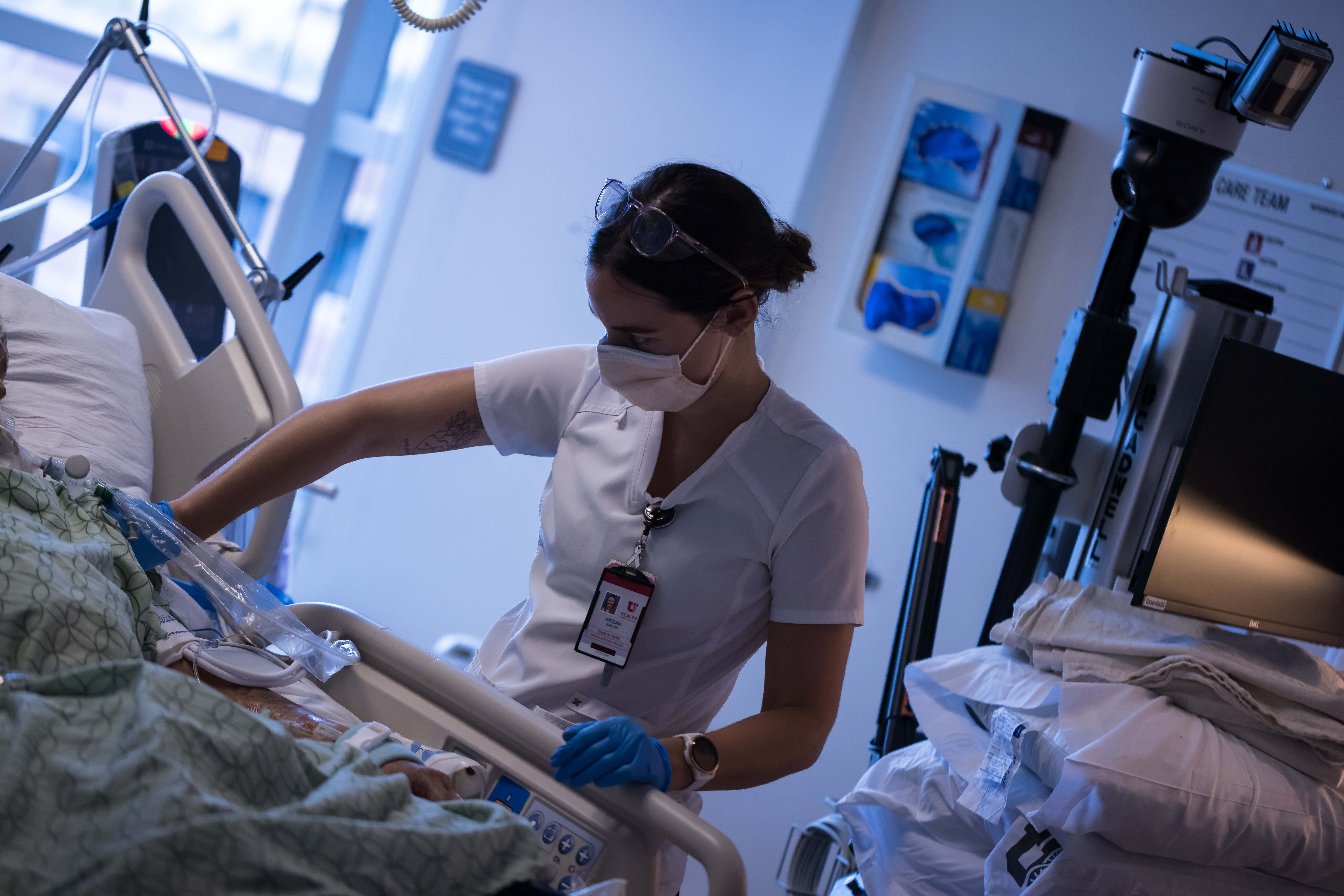 A University of Utah Health worker treats patients inside the medical intensive care unit at University of Utah Hospital on July 30. After several days of near-record COVID-19 hospitalizations in Utah, the state saw a large drop in hospitalizations on Wednesday.