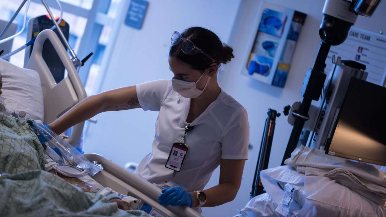 A University of Utah Health worker treats patients inside the medical intensive care unit at University of Utah Hospital on July 30. After several days of near-record COVID-19 hospitalizations in Utah, the state saw a large drop in hospitalizations on Wednesday.