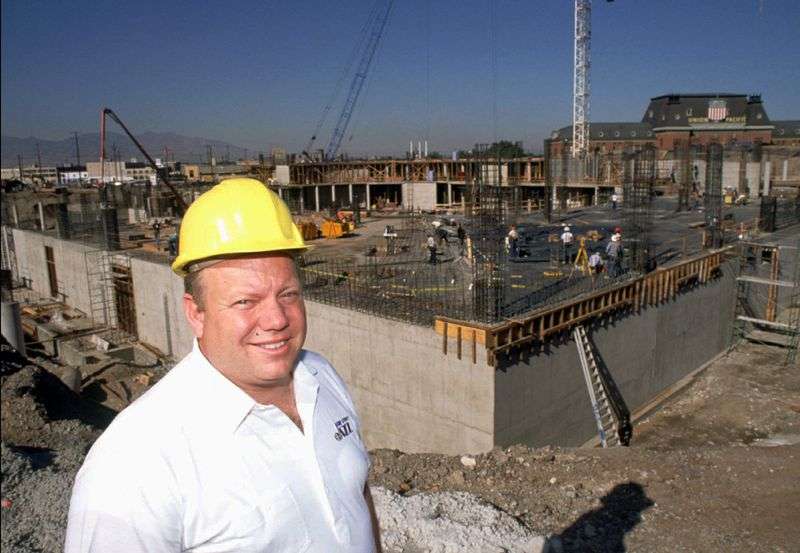 Larry H. Miller stand in front of early construction of
the Delta Center in September 1990.