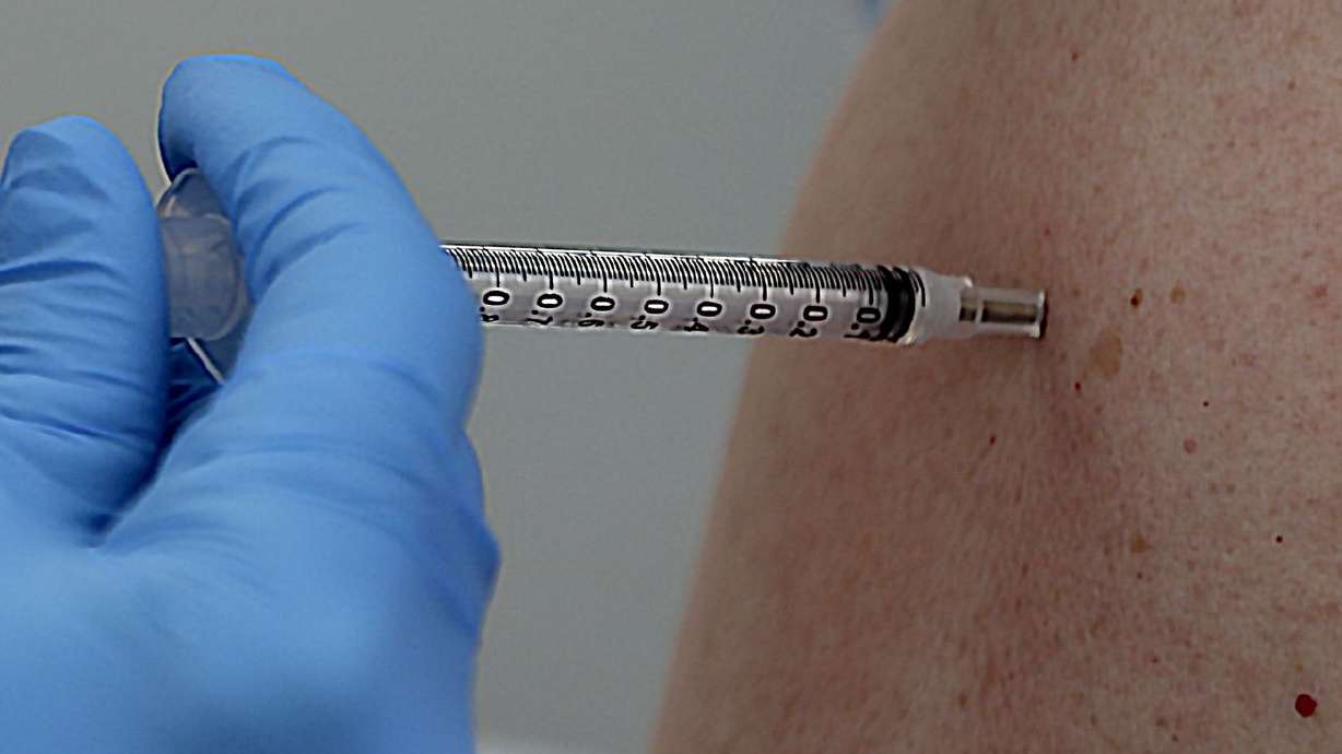 A COVID-19 vaccination is administered at a Salt Lake County Health Department mobile health center at Rose Park
Elementary in Salt Lake City on Sept. 22. While Utah has seen a slight decrease in COVID-19 cases, hospital leaders on Wednesday warned the state is "not out of the woods yet."