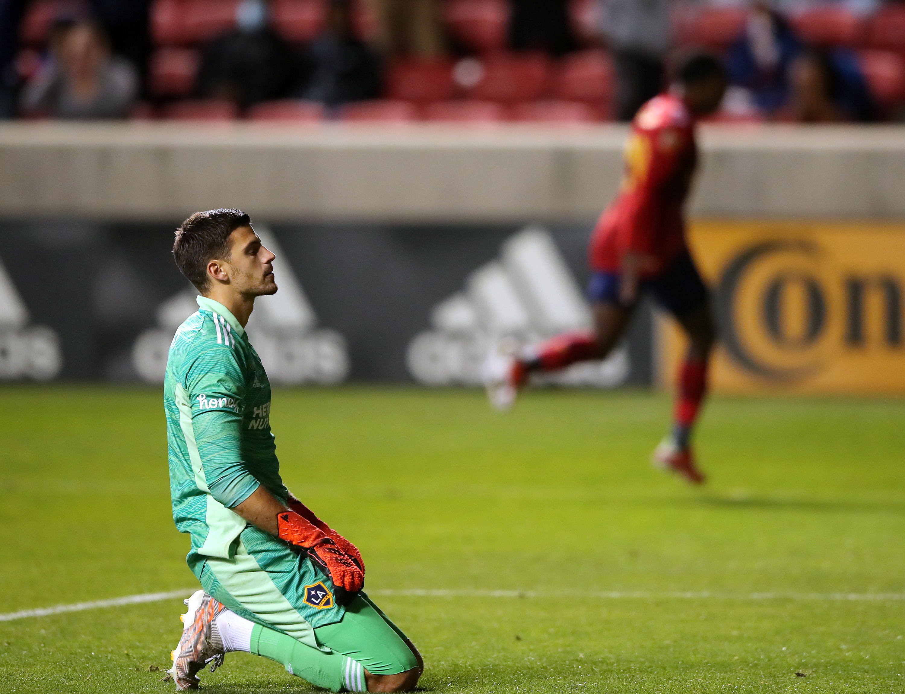 Los Angeles Galaxy goalkeeper Jonathan Bond (1) reacts in disappointment as Real Salt Lake midfielder Anderson Julio (29) celebrates in the background as Real Salt Lake and LA Galaxy play at Rio Tinto Stadium in Sandy on Wednesday, Sept. 29, 2021. RSL won 2-1.