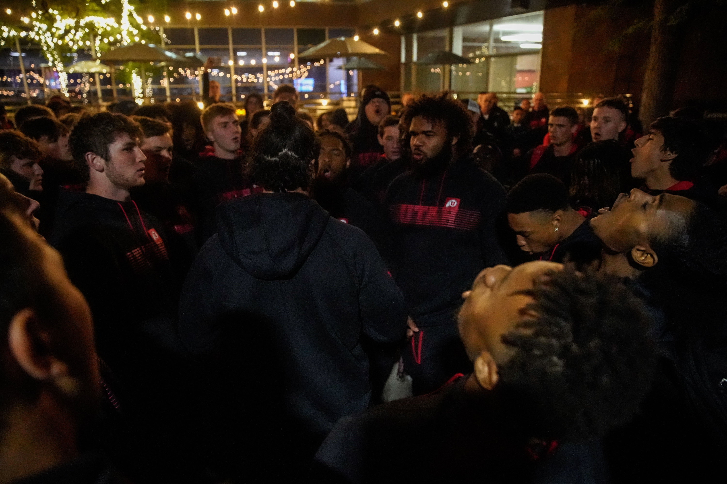 University of Utah football players perform a team chant after a candlelight vigil remembering the life of slain student-athlete Aaron Lowe at the University of Utah in Salt Lake City on Wednesday.