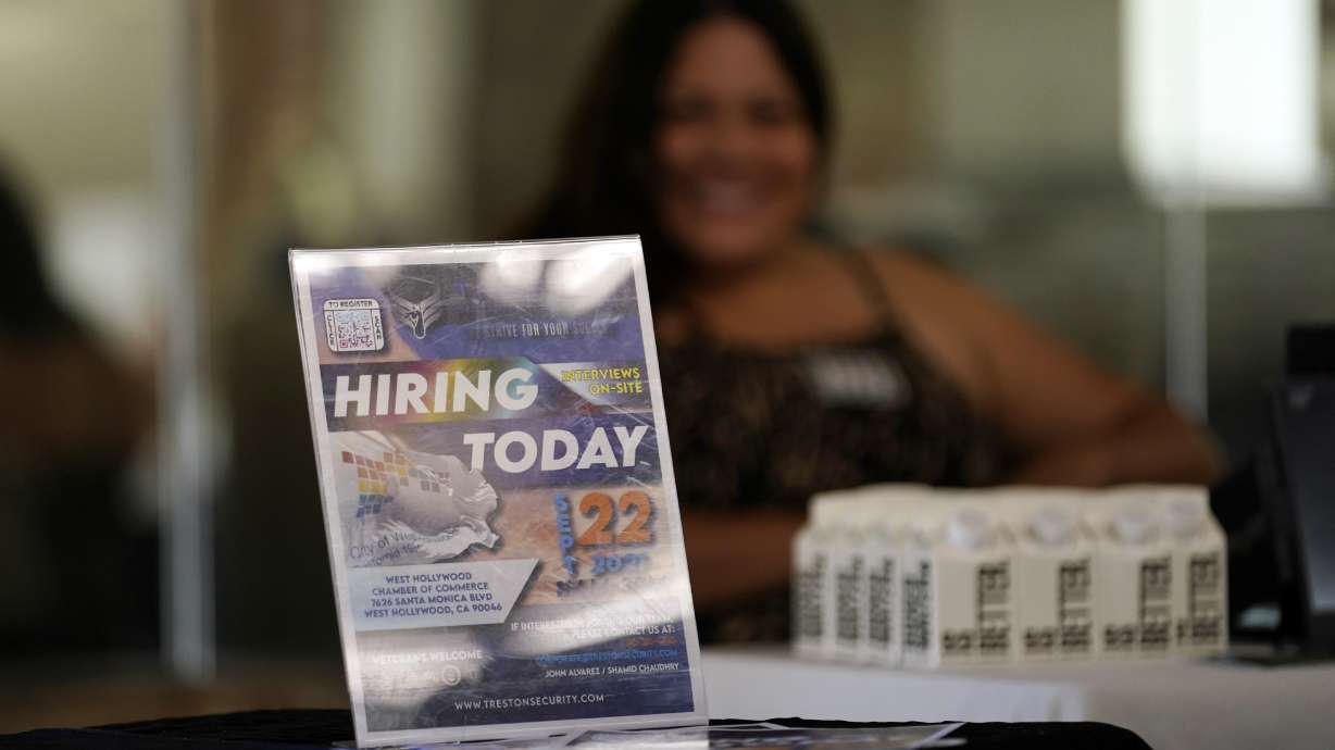 A hiring sign is displayed during a job fair Sept. 22 in West Hollywood, California. The number of Americans applying for unemployment benefits rose for the third straight week Thursday.