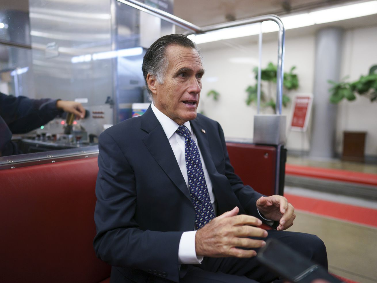 Sen. Mitt Romney, R-Utah, returns to his office after a vote at the Capitol in Washington on Wednesday. Romney wants Democrats to remove "harmful” penalties for marriage from their so-called human infrastructure bill that he says would discourage people from tying the knot.