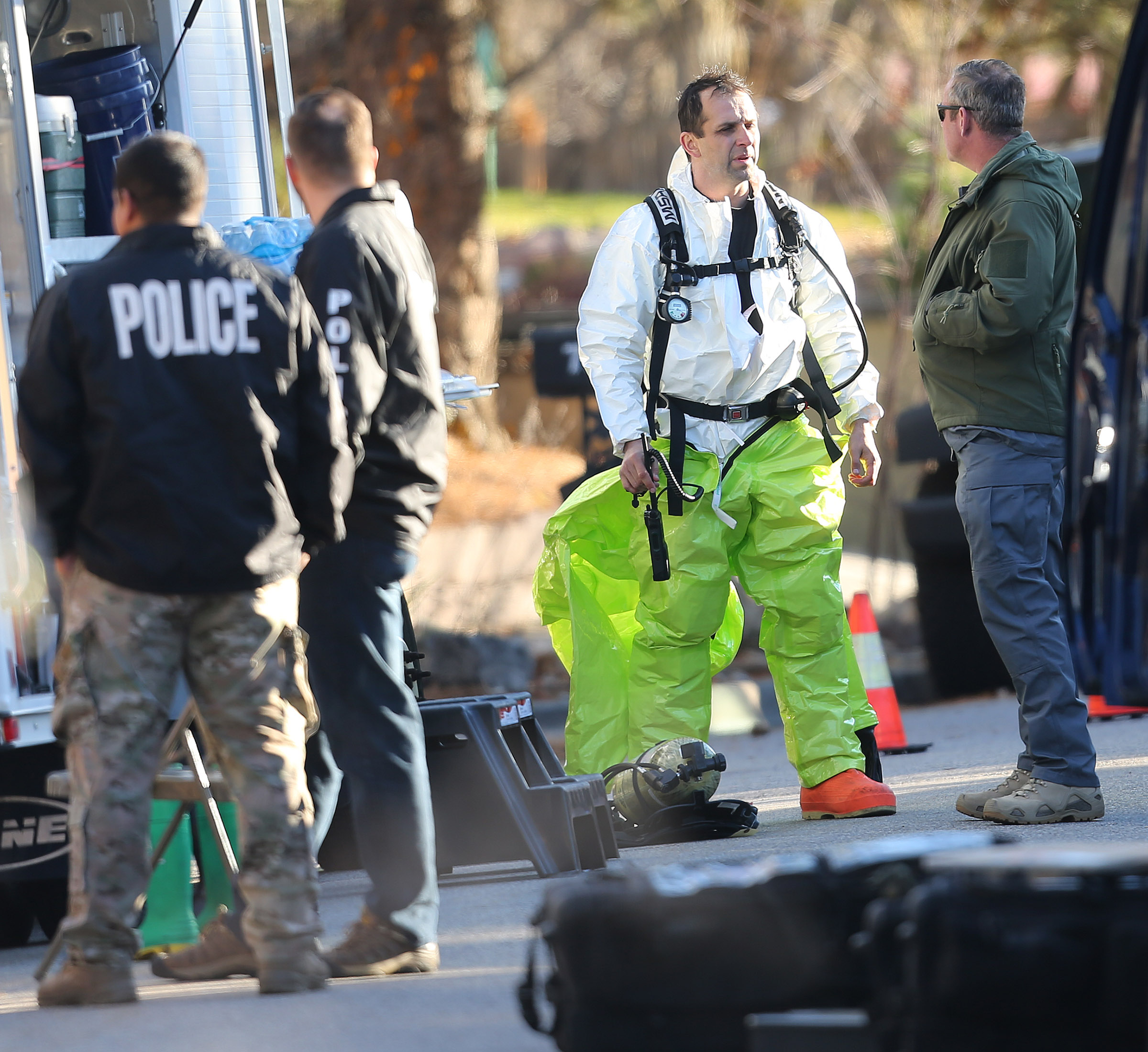 Police and agents with the Drug Enforcement Administration put on protective gear as local and federal law enforcement agencies respond to a fentanyl drug lab bust in Cottonwood Heights on Tuesday, Nov. 22, 2016. DEA agents discovered at least several hundred thousand illicit fentanyl pills at a home in what they called an "absolutely catastrophic" undercover drug dealing operation.