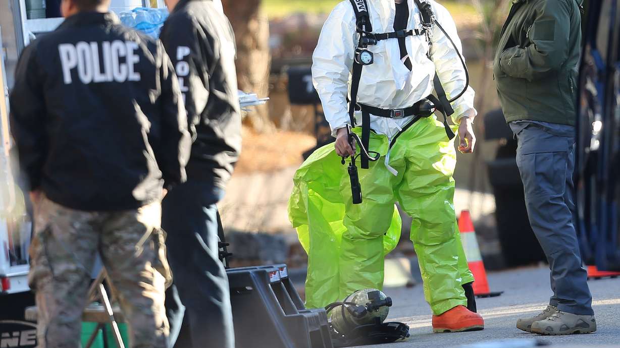 Police and agents with the Drug Enforcement Administration put on protective gear as local and federal law enforcement agencies respond to a fentanyl drug lab bust in Cottonwood Heights on Tuesday, Nov. 22, 2016. DEA agents discovered at least several hundred thousand illicit fentanyl pills at a home in what they called an "absolutely catastrophic" undercover drug dealing operation.