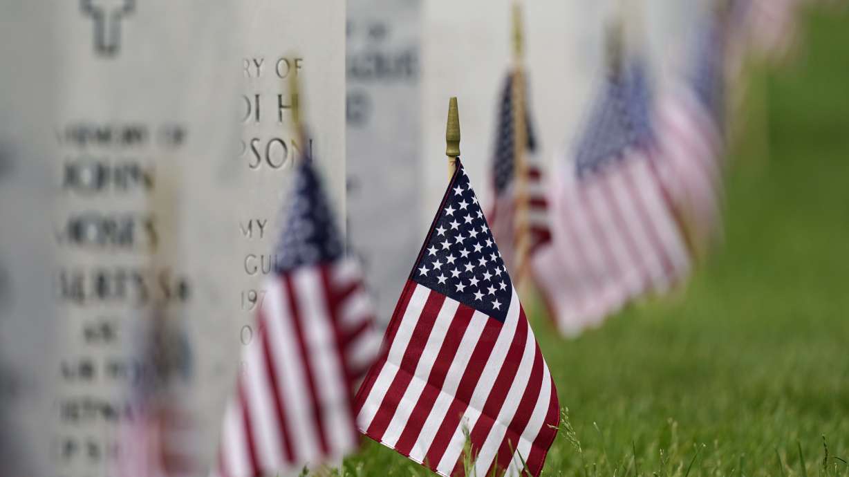 In this May 31 photo, flags and tributes mark the Memorial Day holiday at Fort Logan National Cemetery in southeast Denver. The number of U.S. military suicides jumped by 15% last year, fueled by significant increases in the Army and Marine Corps that senior leaders called troubling.