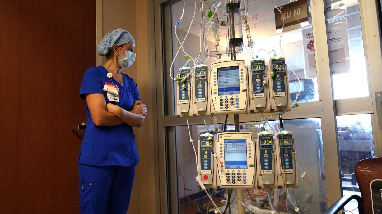 Nursing coordinator Beth Springer looks into a patient's room in a COVID-19 ward at the Willis-Knighton Medical Center in Shreveport, La., on Aug. 17. A decline in COVID-19 cases in the United States over the last several weeks has given overwhelmed hospitals some relief, but administrators are bracing for yet another possible surge as cold weather drives people indoors.