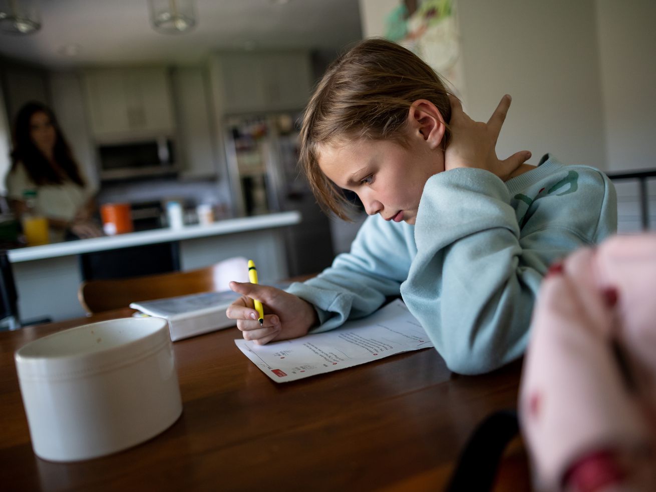 Emery Blackburn, 9, does her homework after returning from school at her home in South Jordan on Sept. 14. Emery and her mother, Ashley, have both experienced long-haul symptoms since the family had COVID-19 in July 2020.