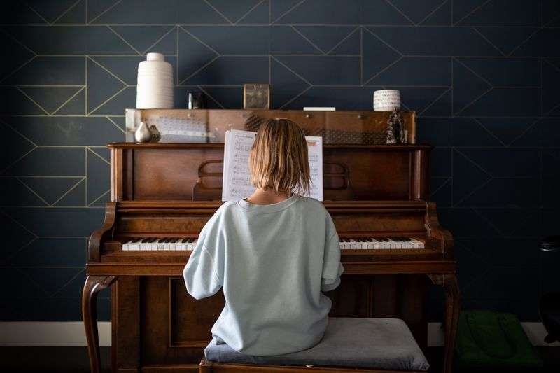 Emery Blackburn, 9, practices piano at her home in
South Jordan on Sept. 14. Emery and her mother,
Ashley, have both experienced long-haul symptoms since the family
had COVID-19 in July 2020.