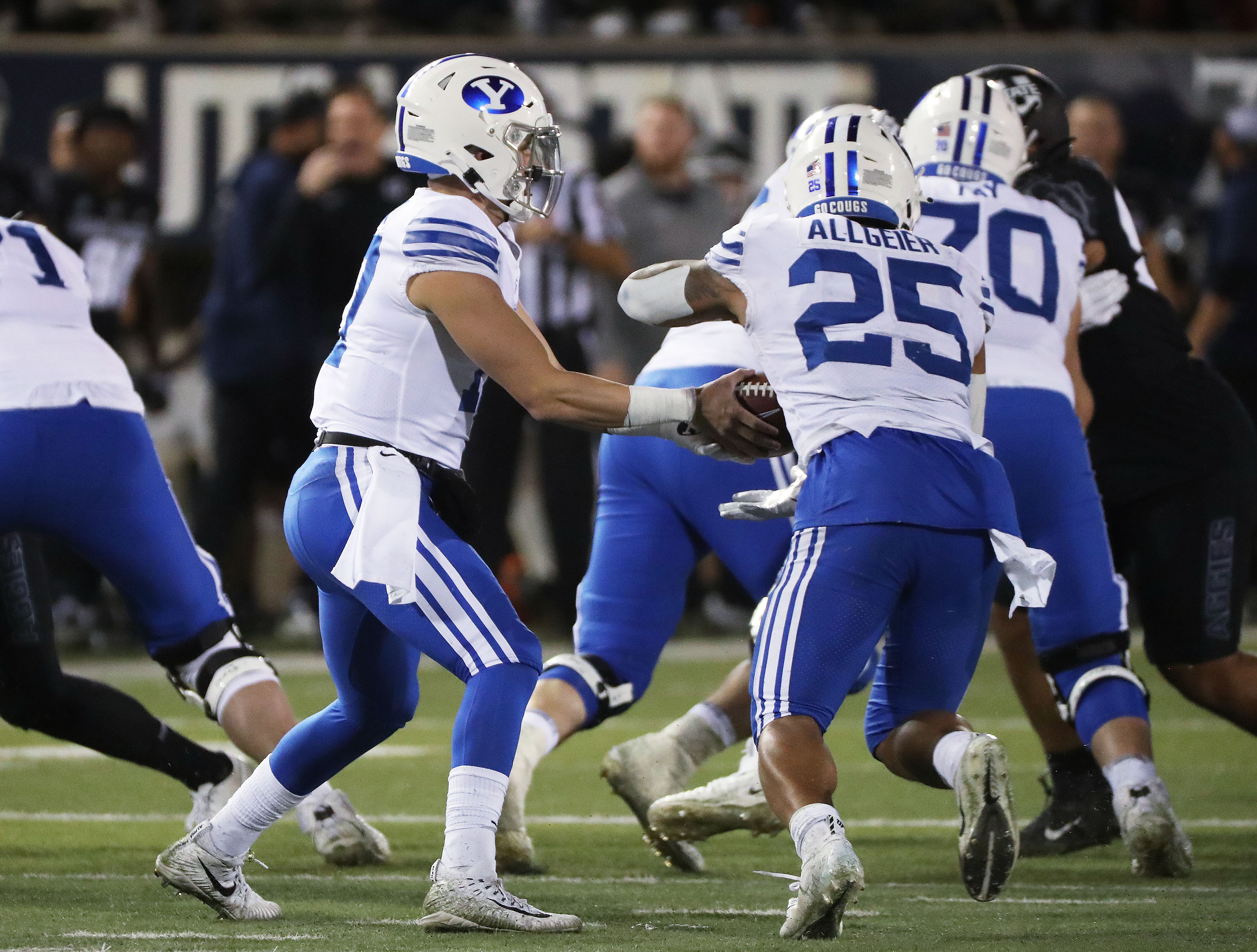 BYU quarterback Jacob Conover (17) hands off to Brigham Young Cougars running back Tyler Allgeier in Logan on Friday, Oct. 1, 2021.