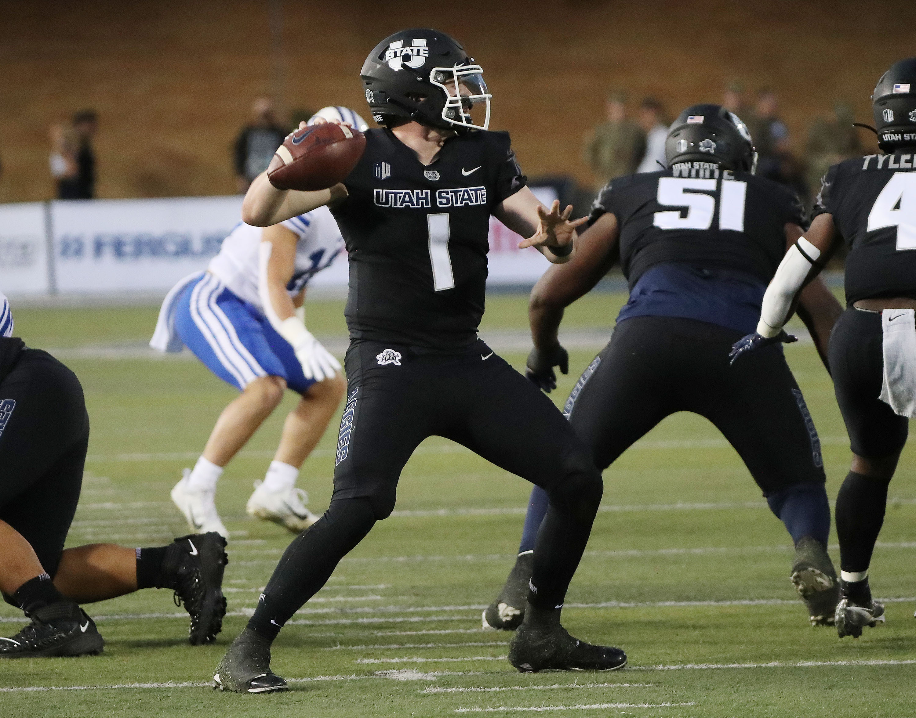 Utah State Aggies quarterback Logan Bonner (1) throws in Logan on Friday, Oct. 1, 2021.