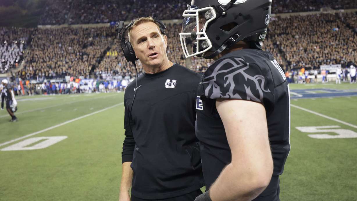 Utah State Aggies head coach Blake Anderson talks with Utah State Aggies quarterback Logan Bonner (1) in Logan on Friday, Oct. 1, 2021.