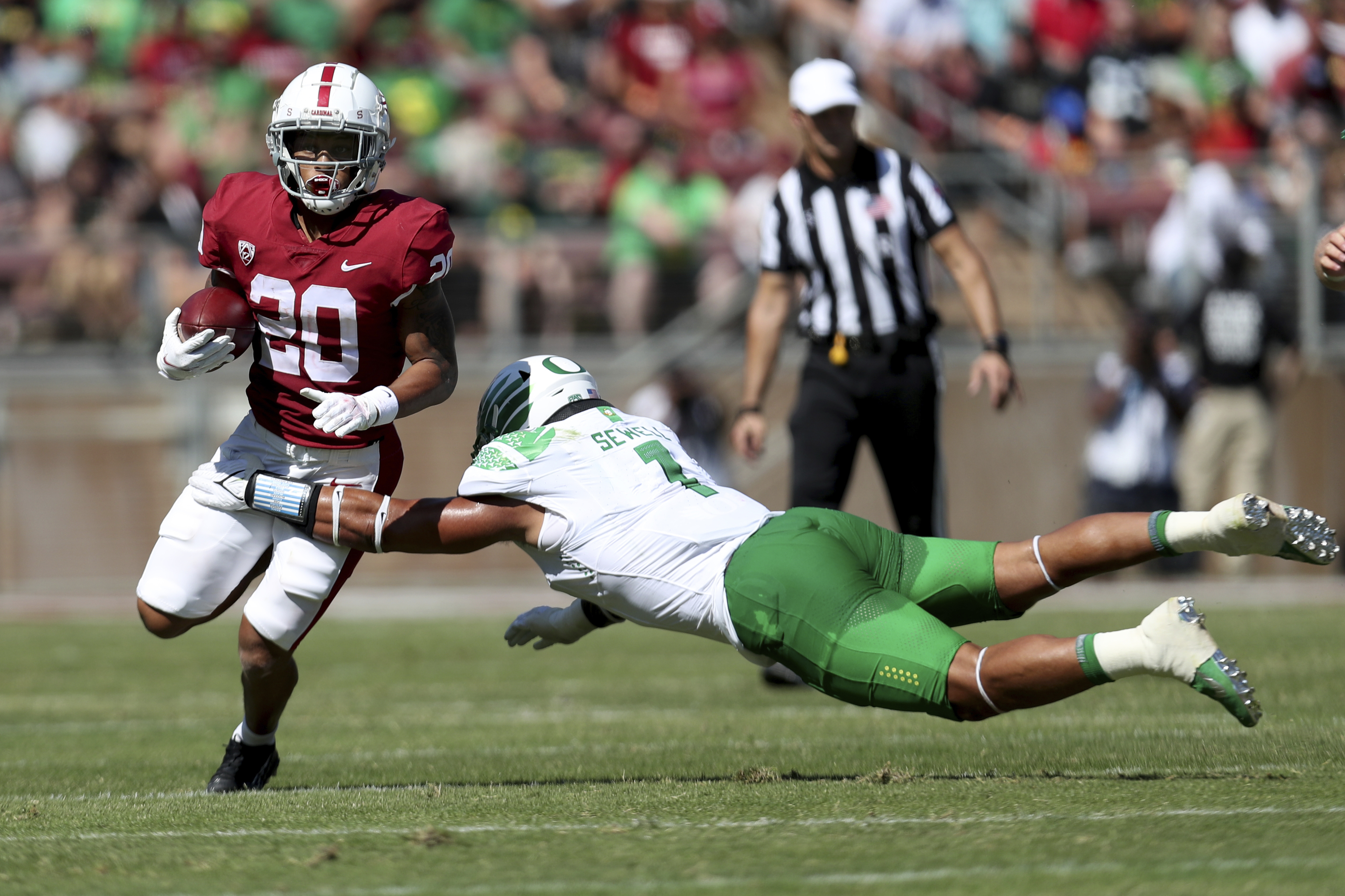 Stanford's Austin Jones, left, runs against Oregons' Noah Sewell, right, during the first half of an NCAA college football game in Stanford, Calif., Saturday, Oct. 2, 2021.