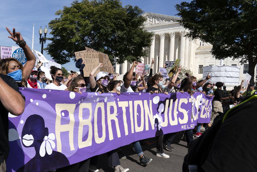 Thousands of demonstrators march outside the U.S. Supreme Court during the Women's March in Washington on Saturday. The Biden administration on Monday reversed a ban on abortion referrals by family planning clinics, lifting a Trump-era restriction