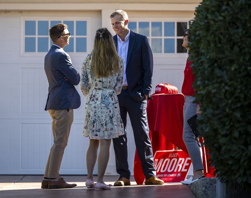 Rep. Blake Moore, R-Utah, right, talks with supporters at a fundraiser for his campaign in Salt Lake City on Monday. Moore invited Rep. Liz Cheney, R-Wyo., to the event, but an apparent flight delay kept her from attending.